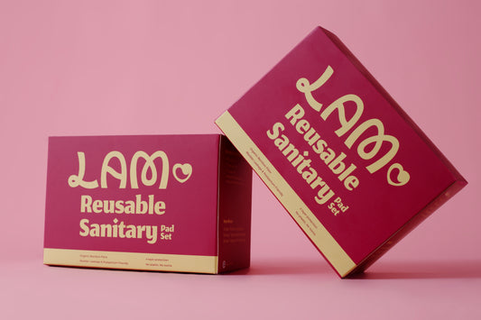 This image features a set of reusable sanitary pads packaged in a vibrant pink box with the brand name "LAM" prominently displayed. The packaging is elegant with a modern design, highlighting the eco-friendly nature of the product.